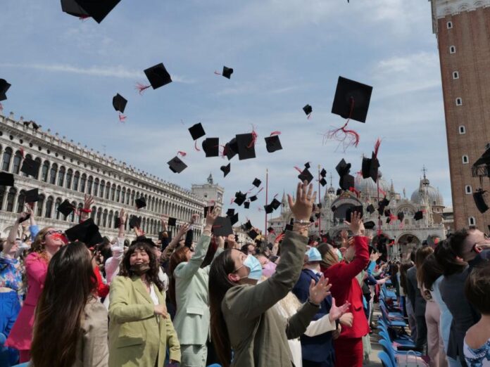 Il classico lancio in aria del tocco, che ha chiuso la cerimonia di laurea in Piazza San Marco